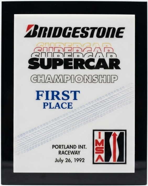 A reproduction of the Bridgestone Supercar Championship first-place plaque for the Portland round of 26 July 1992, one of Doc Bundy’s three wins that …