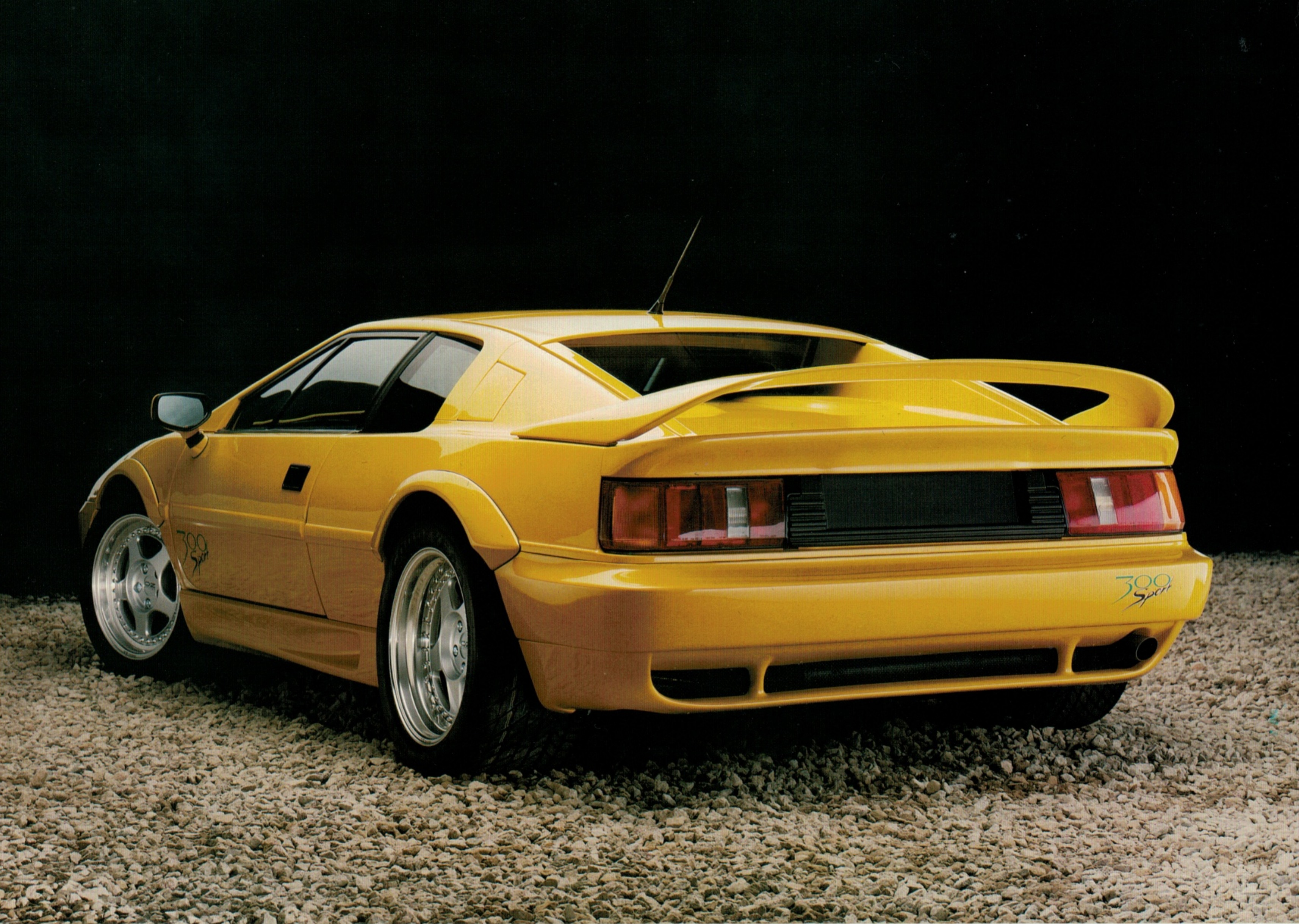 The leaflet’s photographic side: the Sport 300 on gravel, wearing the 300 Sport script and the deep front airdam. The page was scanned sideways; it is …