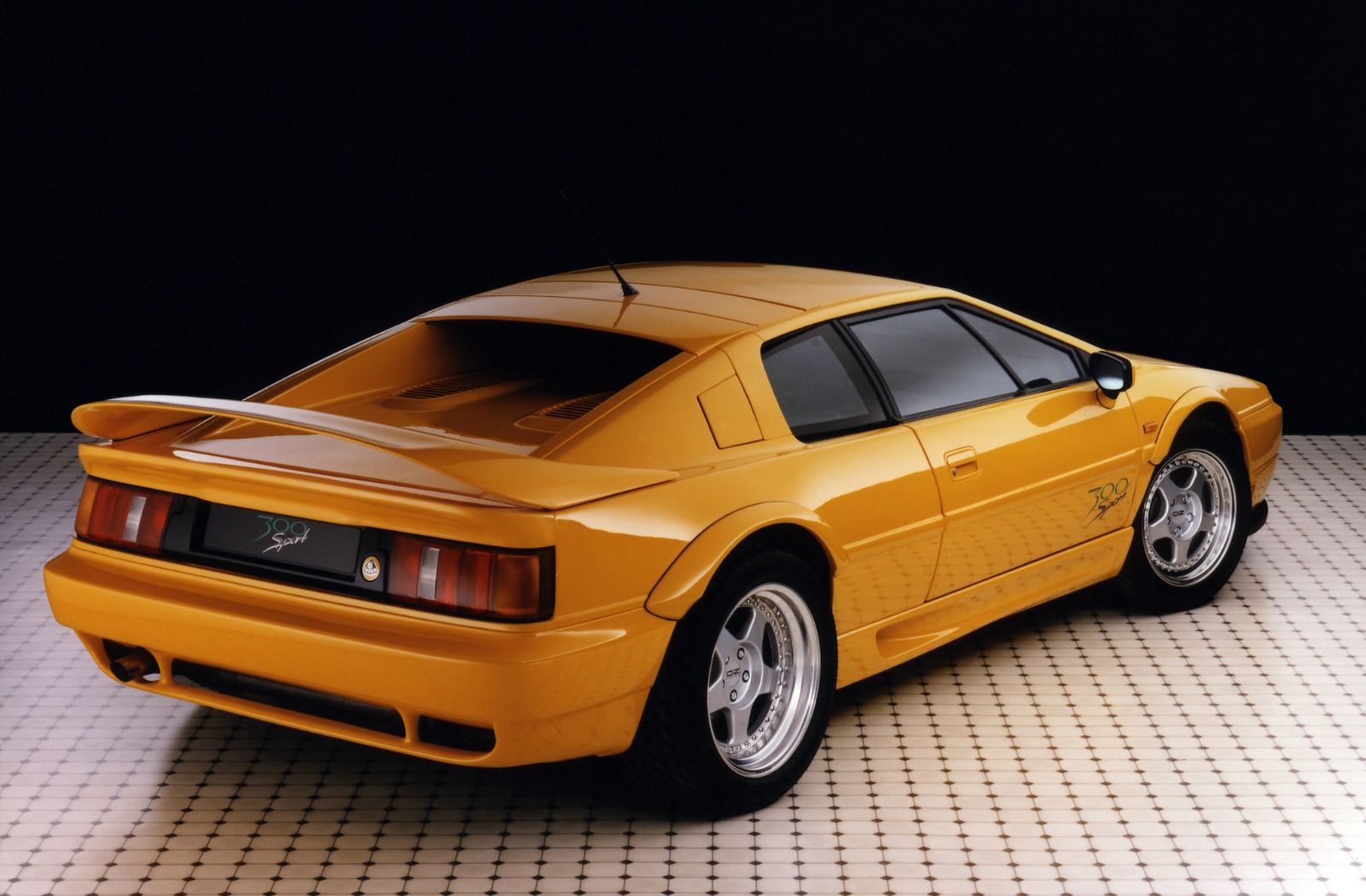 The rear three-quarter, where the aerofoil and the 315/35 R17 rear tires do most of the talking. The decals read 300 Sport; the factory’s own leaflet, …
