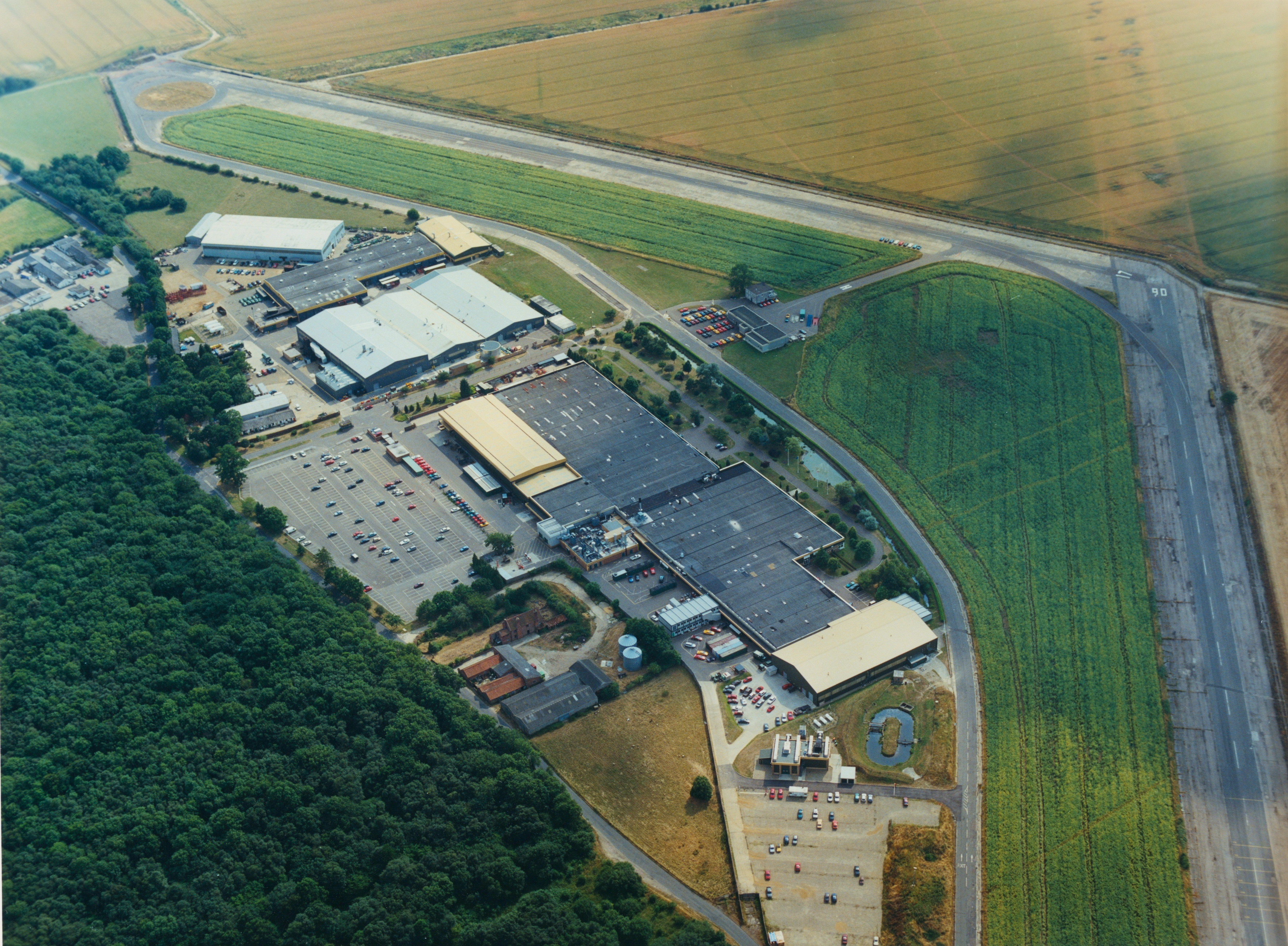 The Lotus factory at Hethel, Norfolk, photographed from the air in 1991 — the year the X180R was built and shaken down here. The perimeter road …